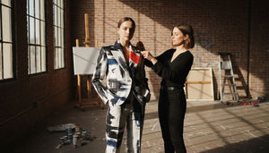 Art stylist adjusting model in urban studio